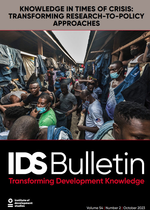 This photo is the cover to IDS Bulletin 54.2. It features men at a clothes and shoe market.